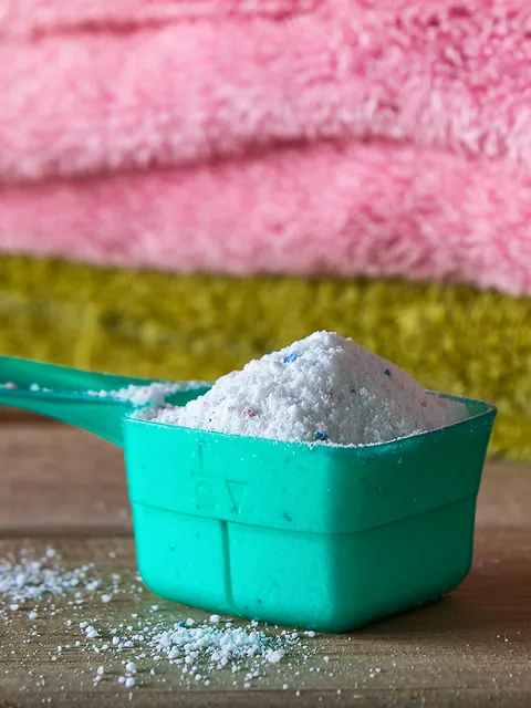 Powder detergent dispenser next to towels